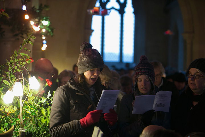 People sing Christmas carols at the fifth annual carol service being held inside the 13th century St Giles church in the village of Imber on December 21, 2013 on Salisbury Plain, England.