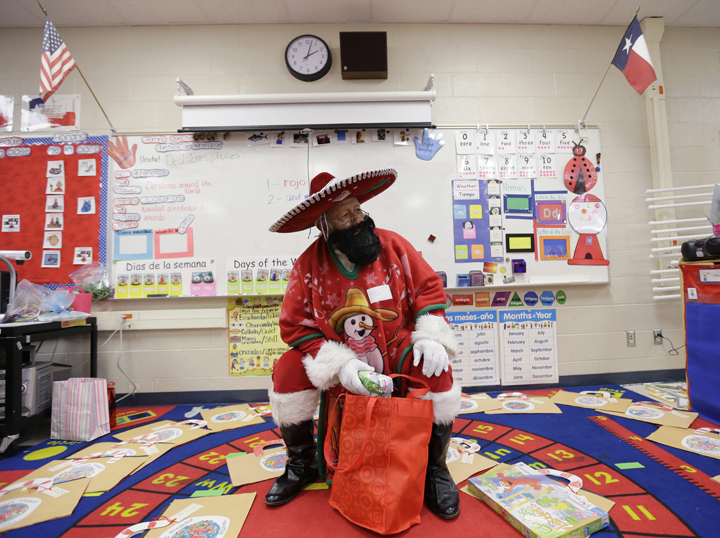 Pancho Claus, Rudy Martinez, prepares to hands out gifts in a class during a visit to Knowlton Elementary School, in San Antonio. Pancho Claus, a Tex-Mex Santa borne from the Chicano civil rights movement in the late 1970s and early 1980s, is now an adored Christmas fixture in many Texas cities.