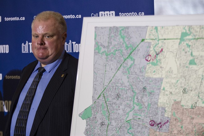 Toronto Mayor Rob Ford stands next to a map of the city at a news conference after an ice storm left over 250,000 customers across the city without power on Sunday, December 22, 2013.
