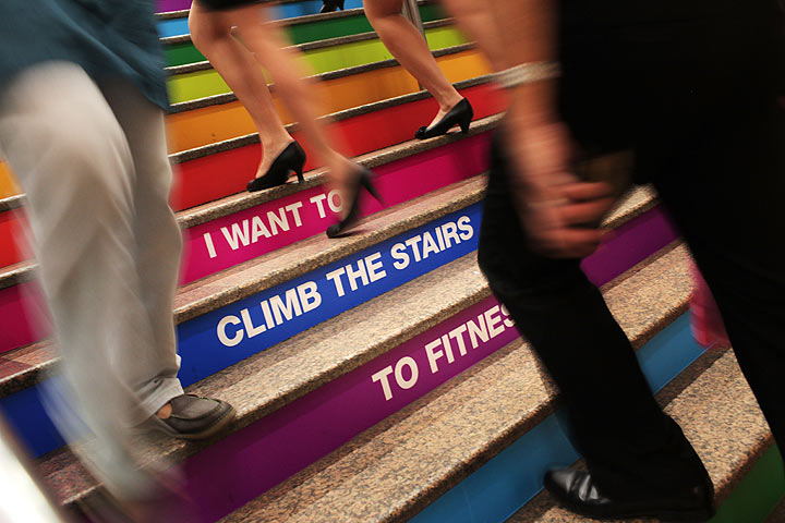 Commuters walk up the redesigned subway stairs at the Tanjong Pagar subway station on August 23, 2011 in Singapore. The subway stairs have been repainted in bright colours and slogans encouraging people to take the stairs, by way of promoting fitness in the city. (Photo by Chris McGrath/Getty Images)