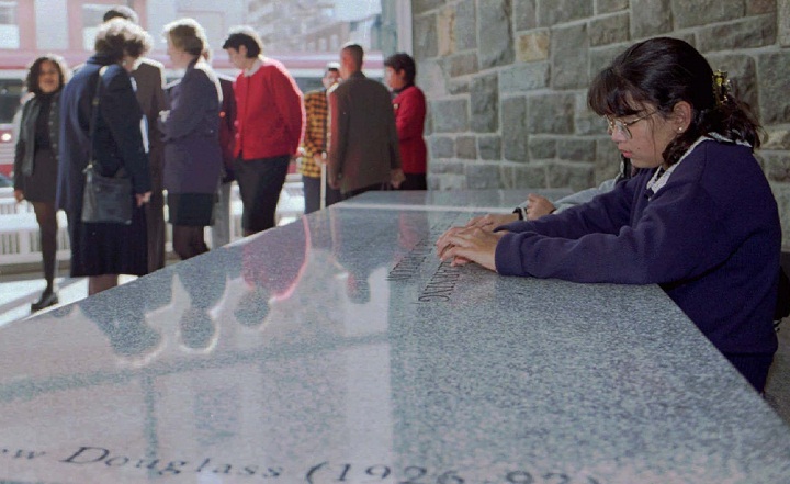 Jennifer Douglass sits at a granite table dedicated to her father, Matthew Douglass, a Concordia University professor who was murdered by colleague Valery Fabrikant on August 24, 1992.