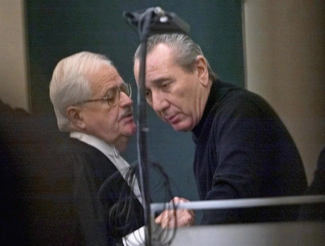 File photo - Vito Rizzuto (right) speaks with his attorney Jean Salois in Montreal on Feb. 6, 2004.