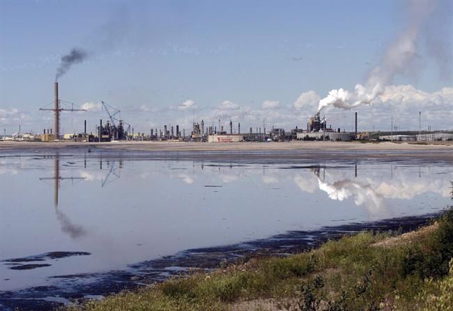 A tailings pond reflects the Syncrude oilsands mine facility near Fort McMurray, Alta., on July 9, 2008. 