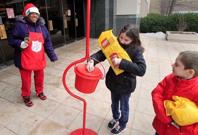 FILE PHOTO: Salvation Army bell ringer Stephanie Beavers happily accepts donations from Shelby Merkel.
