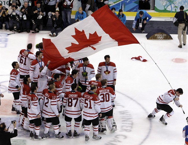Canada's Drew Doughty (8) waves a Canadian flag after the men's ice hockey medal ceremony at the Vancouver 2010 Olympics