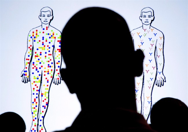 Members of the audience look at slides projected on video screens during the XIX International AIDS Conference, in Washington, July 25, 2012.