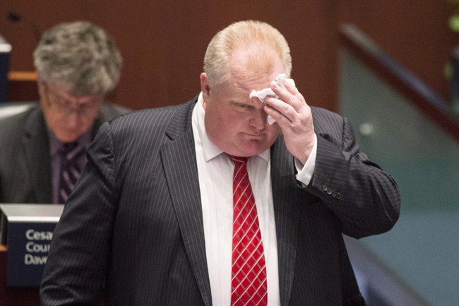 Toronto Mayor Rob Ford wipes his brow in the council chamber at city hall as councillors look to pass motions to limit his powers on Monday November 18, 2013. 