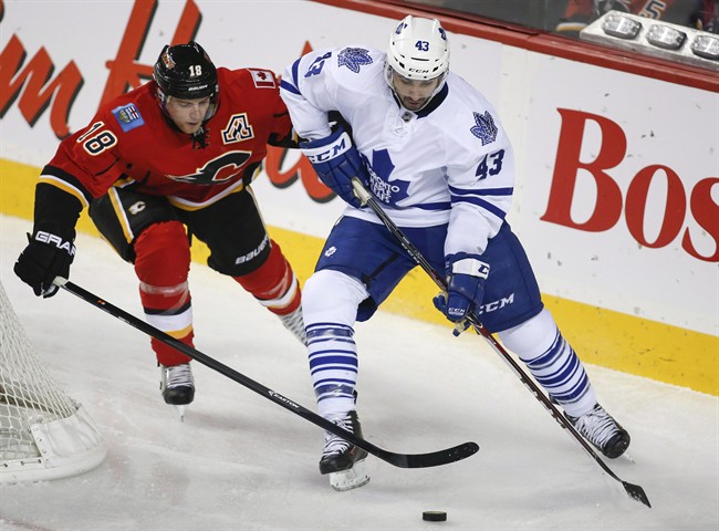 Toronto Maple Leafs' Nazem Kadri, right, chases the puck with Calgary Flames' Matt Stajan during second period NHL hockey action in Calgary, Alta., Wednesday, Oct. 30, 2013.