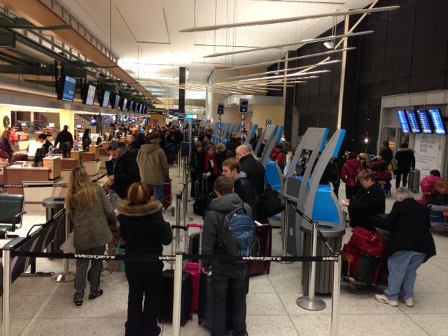 Passengers at the Edmonton International Airport Monday, December 23, 2013.
