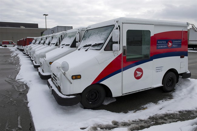 Canada Post trucks sit in a parking lot at the Gateway sorting facility in Mississauga, Ontario on Wednesday December 18, 2013.