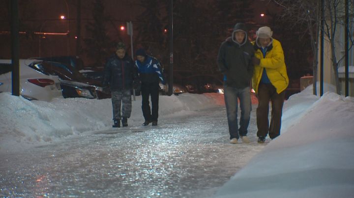 Edmonton pedestrians held on to each other while walking on extremely slippery sidewalks Saturday, Dec. 14, 2013.