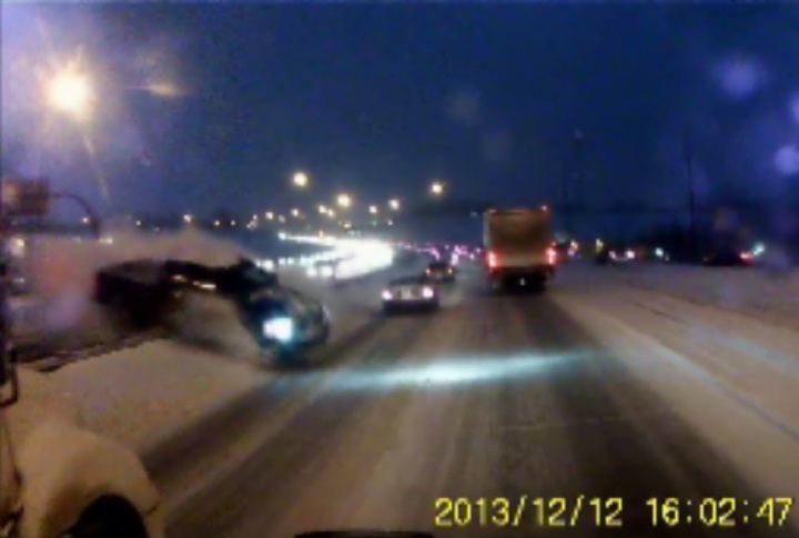 Dash cam video shows a truck crossing the median on Glenmore Trail.