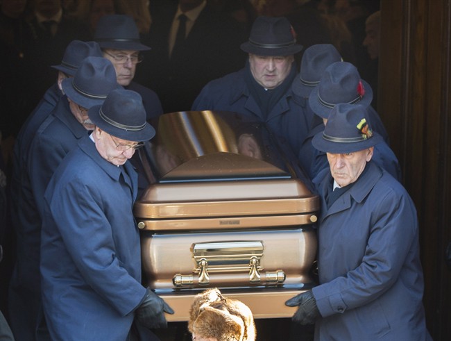 Pallbearers carry the coffin of reputed mafia boss Vito Rizzuto from a church in Montreal, Monday, Dec. 30, 2013, following his funeral. Rizzuto died last week from natural causes.