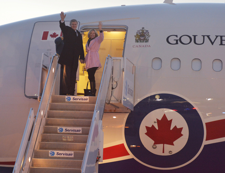 Prime Minister Stephen Harper and his wife Laureen board a flight for South Africa to attend a memorial for Nelson Mandela, in Ottawa, Sunday, Dec.8, 2013.