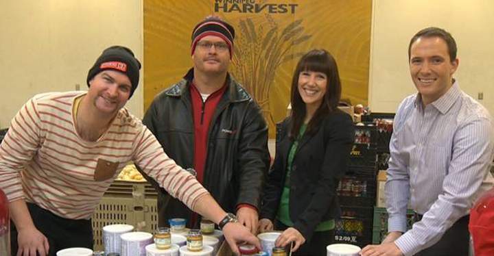 TJ Connors (left) and Cam Carson of Power 97, Kim Kaschor of Shaw TV and Mike Koncan (right) of Global News help out Winnipeg Harvest.