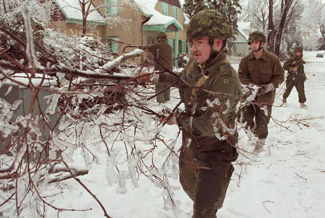 Cpl. Chris Mckee (centre) along with other members of the Royal Canadian Dragoons clear branches from roads in the east end of Ottawa after a devastating ice storm struck eastern Ontario and parts of Quebec in 1998.