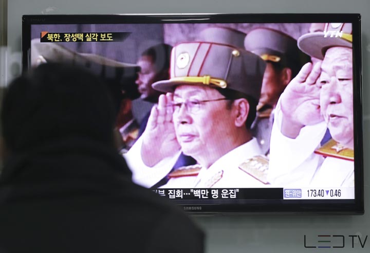 A man watches a TV news program showing an image of North Korean leader Kim Jong Un's uncle, Jang Song Thaek, left, at the Seoul Railway Station in Seoul, South Korea, Monday, Dec. 9, 2013. 