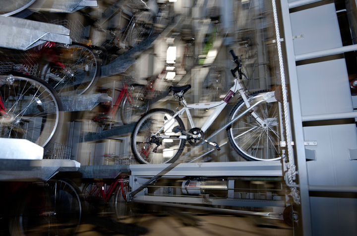 The carrier lift then pulls out the bicycle and moves it back up above ground. (Photo credit: Keith Tsuji/Getty Images)