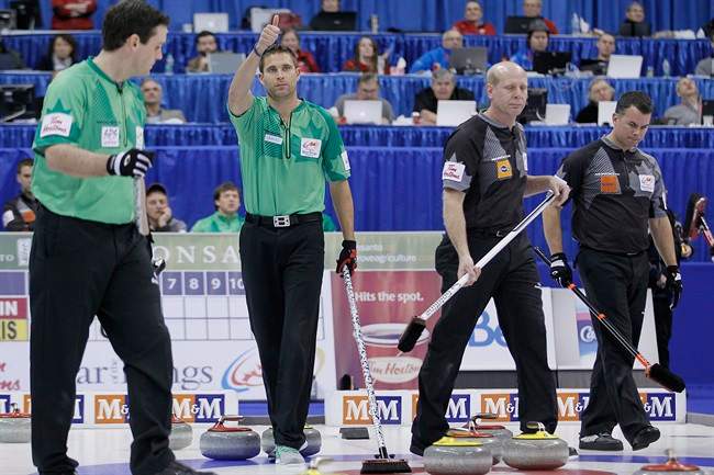 Skip John Morris gives a thumbs up as they get two points on Kevin Martin and his third David Nedohin during the sixth end in the men's semi-final at the 2013 Roar of the Rings Canadian Olympic Curling Trials in Winnipeg, Saturday, December 7, 2013. 
