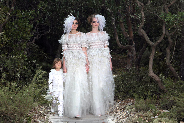 Models present creations for Chanel with Hudson Kroenig, German designer Karl Lagerfeld’s godson, during the Haute Couture Spring-Summer 2013 collection shows on January 22, 2013 at the Grand Palais in Paris. (Photo: LOIC VENANCE/AFP/Getty Images)