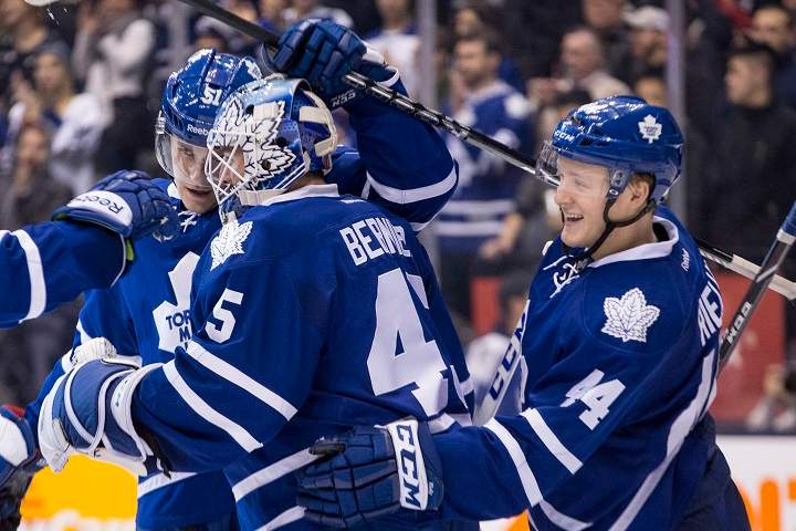 Toronto Maple Leafs goaltender Jonathan Bernier (centre) is congratulated by Leafs defencecmen Jake Gardiner (left) and Morgan Rielly after their 5-2 win over Carolina Hurricanes in NHL hockey action in Toronto on Sunday December 29, 2013.