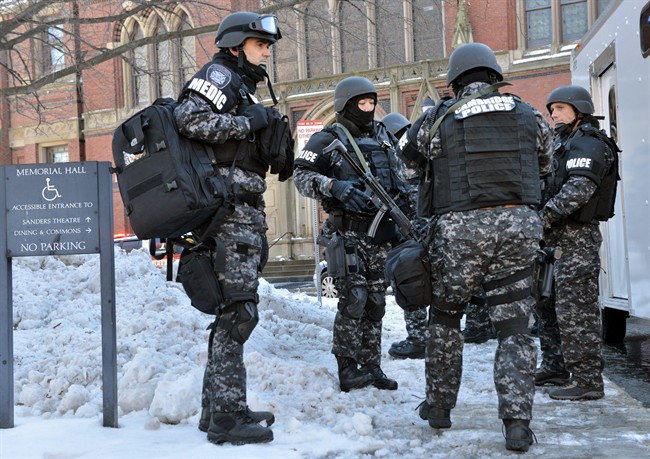 Tactical police assemble outside a building at Harvard University in Cambridge, Mass., Monday, Dec. 16, 2013. 
