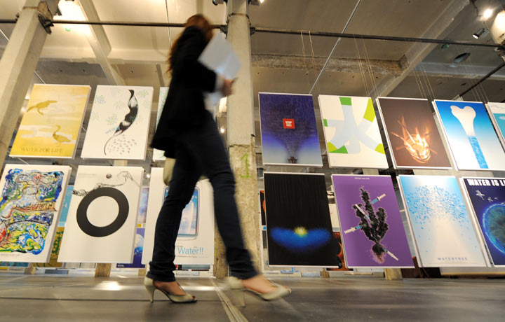 A woman visits the poster exhibition ‘Water for Life’ on the day of its inauguration on June 10, 2009 at the Matadero museum in Madrid. (Photo by JAVIER SORIANO/AFP/Getty Images)