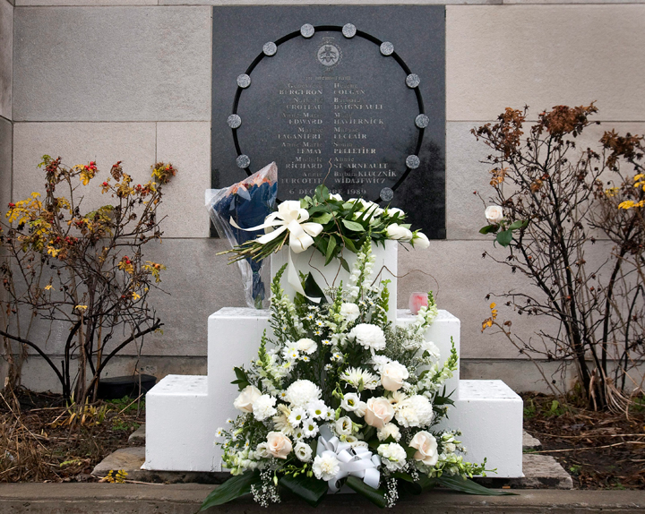 Flowers sit in front of the memorial plaque at the Ecole Polytechnique on the 22nd anniversary of the Montreal massacre, Tuesday, December 6, 2011 in Montreal. 