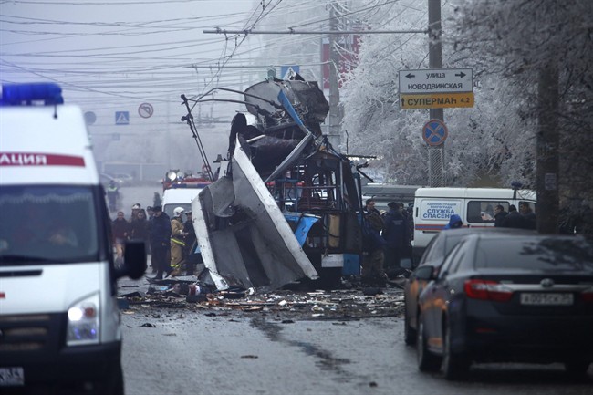 Experts and police officers examine a site of a trolleybus explosion in Volgograd, Russia Monday, Dec. 30, 2013. 