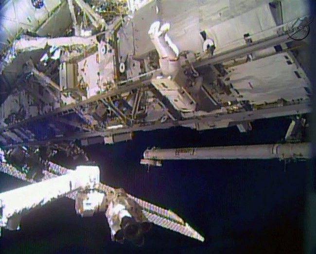 In this image made from video provided by NASA, astronaut Rick Mastracchio performs a space walk outside the International Space Station on Saturday, Dec. 21, 2013. 