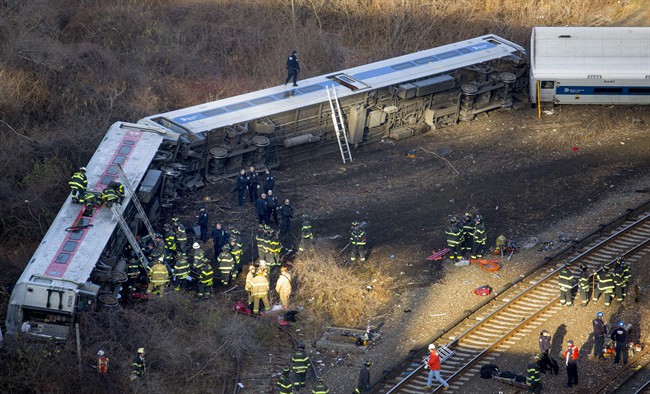 First responders gather at the derailment of a Metro-North passenger train in the Bronx borough of New York Sunday, Dec. 1, 2013. (AP Photo/Craig Ruttle)