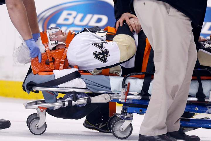 Pittsburgh Penguins' Brooks Orpik is taken off the ice after being injured in the first period of an NHL hockey game against the Boston Bruins in Boston, Saturday, Dec. 7, 2013.