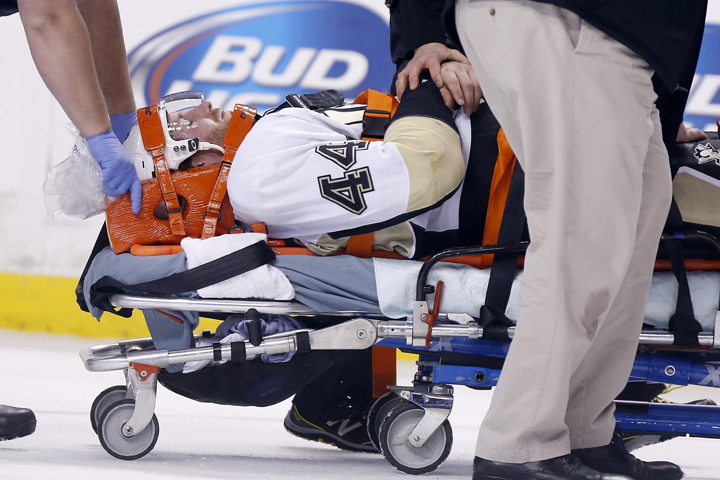 Pittsburgh Penguins' Brooks Orpik is taken off the ice after being injured in the first period of an NHL hockey game against the Boston Bruins in Boston, Saturday, Dec. 7, 2013.