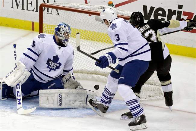 Pittsburgh Penguins right wing Chris Conner (23) gets the puck behind Toronto Maple Leafs goalie Jonathan Bernier (45) and Dion Phaneuf (3) for a goal in the first period of an NHL hockey game, Monday, Dec. 16, 2013, in Pittsburgh. (AP Photo/Gene J. Puskar).
