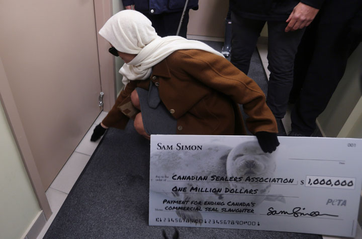 Pamela Anderson slips a letter under the door of the Canadian Sealers Association office in St. John's.