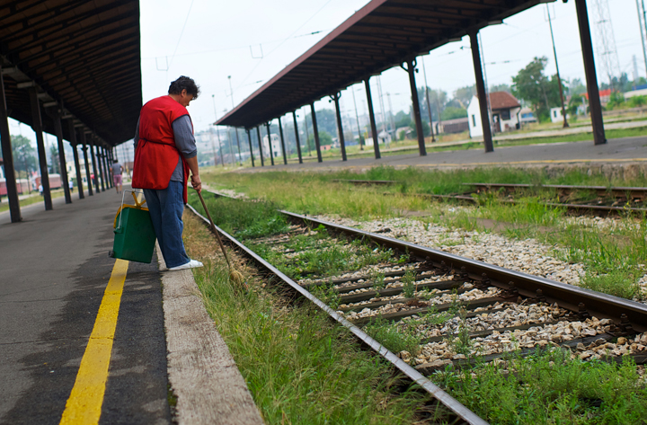  A Serbian railway worker collects waste at Belgrade's Central railway station on August 29, 2013. 