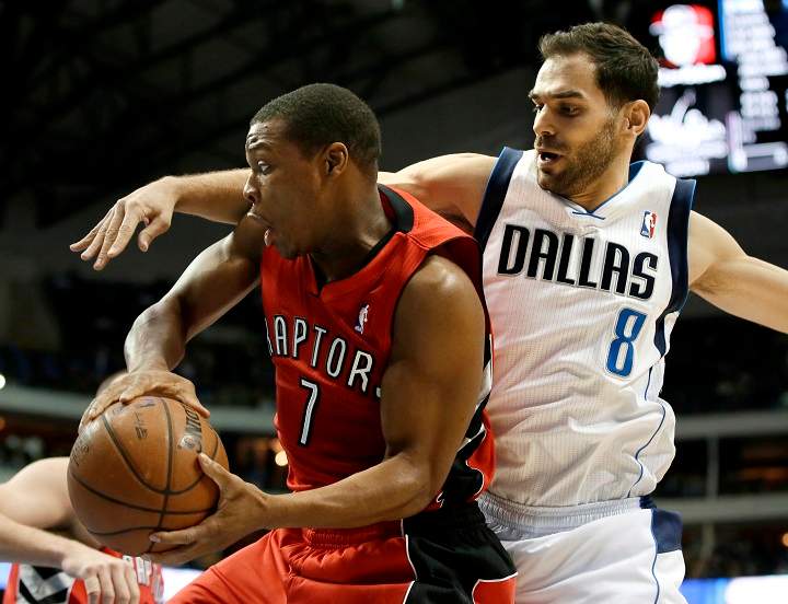 Toronto Raptors' Kyle Lowry (7) is fouled by Dallas Mavericks' Jose Calderon (8), of Spain, in the first half of an NBA basketball game, Friday, Dec. 20, 2013, in Dallas. 