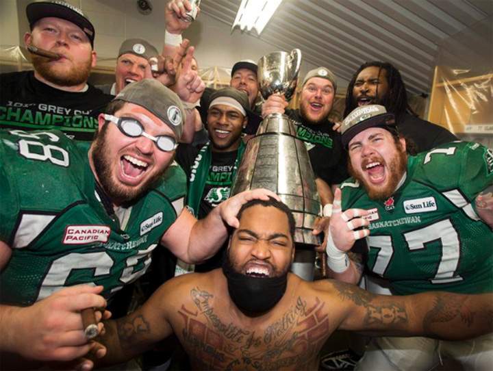 Saskatchewan Roughriders running back Kory Sheets, center, celebrates with his offensive linemen after beating the Hamilton Tiger-Cats to win the Grey Cup Sunday, November 24, 2013 in Regina.The Roughriders successfully shouldered the weight of heavy expectations and overcame adversity in 2013, capping the year with a dominant 45-23 Grey Cup win over the Hamilton Tiger-Cats on Nov. 24. THE CANADIAN PRESS/Frank Gunn