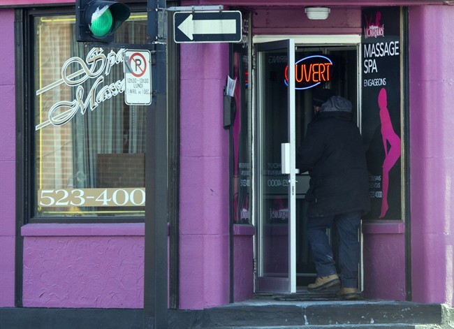 A man enters a massage parlour in Montreal. In 2012, the government stopped issuing temporary foreign worker permits to sex industry workers in an effort to crack down on human trafficking.