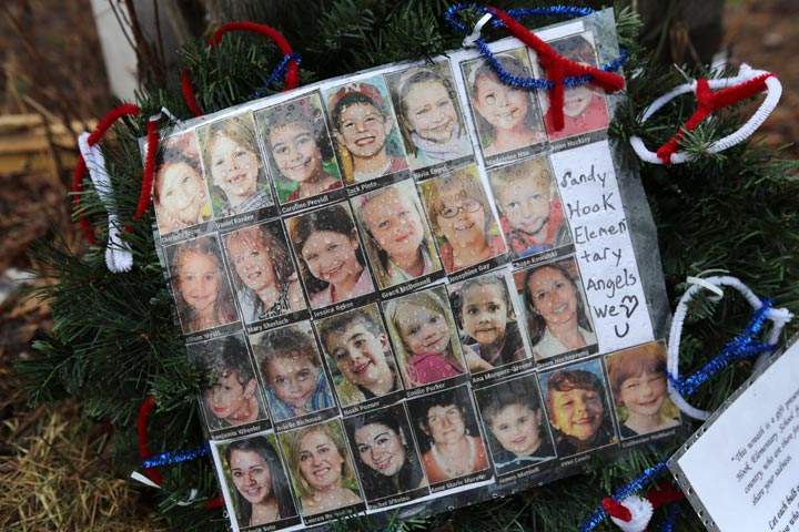 Photos of Sandy Hook Elementary School massacre victims sits at a small memorial near the school on January 14, 2013 in Newtown, Connecticut. 