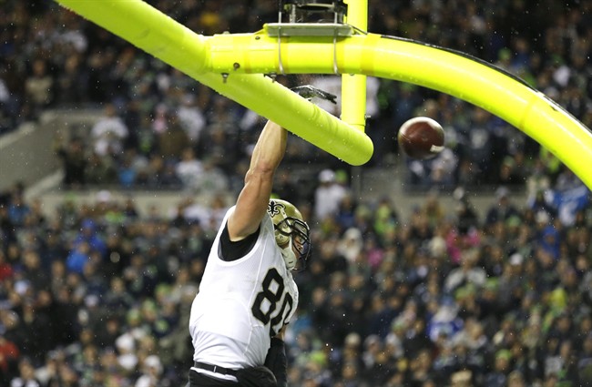 New Orleans Saints' Jimmy Graham spikes the ball through the goal posts after he scored a touchdown in the first half of an NFL football game against the Seattle Seahawks, Monday, Dec. 2, 2013, in Seattle.