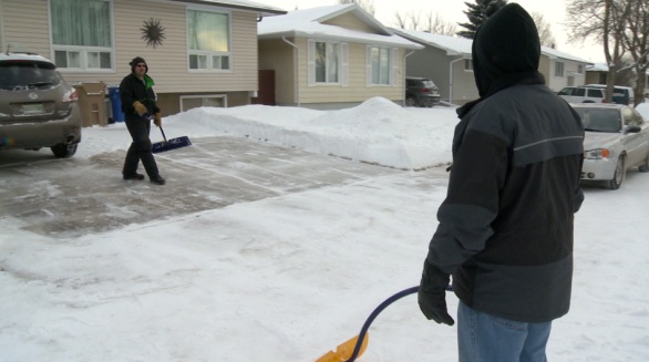 Paul Leier (left) and Dwight Jensen (right) were out Saturday morning shoveling their sidewalks.