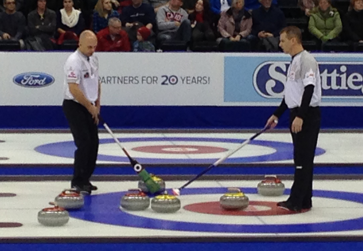 Jon Mead and Jeff Stoughton discuss their next shot in Monday's game at the Olympic curling trials.