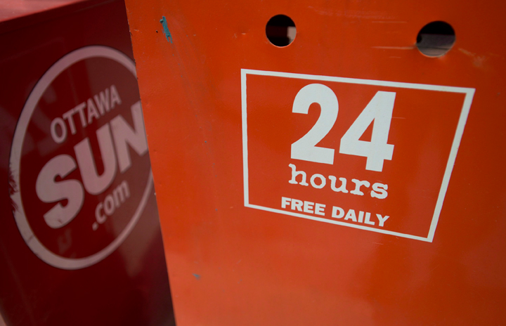 A 24hours newspaper box sits beside The Ottawa Sun in Ottawa on Tuesday, July 16, 2013. Sun Media Corp. said Wednesday it is cutting about 200 jobs across the company, of which about a quarter will come from its editorial operations.