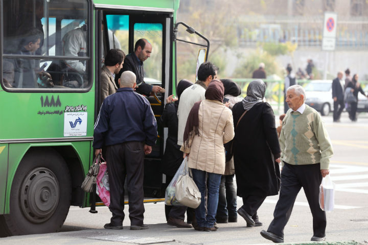Iranians get out of a bus in the capital Tehran on November 24, 2013