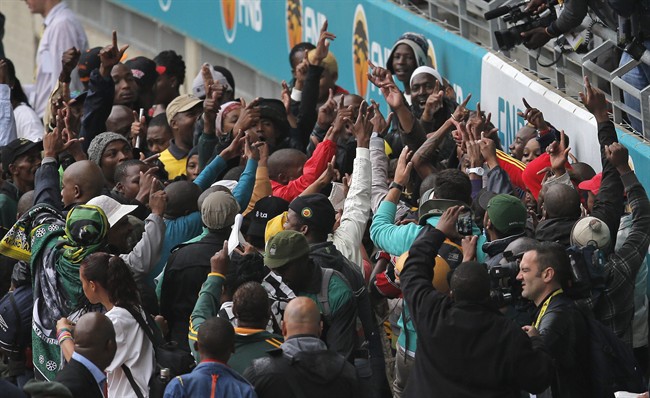 People dance as they arrive for the memorial service for former South African president Nelson Mandela at the FNB Stadium in Soweto, near Johannesburg, South Africa, Tuesday Dec. 10, 2013. Mandela died on Thursday Dec. 5, aged 95.