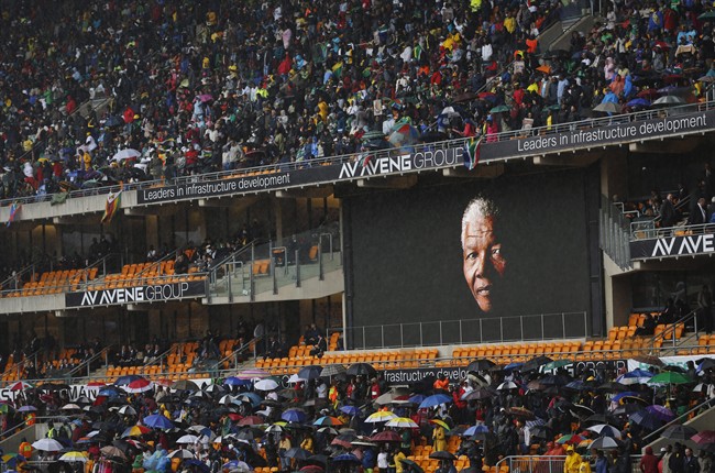 The face of Nelson Mandela is shown on a large billboard in the stands at the memorial service for former South African President Nelson Mandela at the FNB Stadium in the Johannesburg, South Africa township of Soweto, Tuesday Dec. 10, 2013. (AP Photo/Ben Curtis)