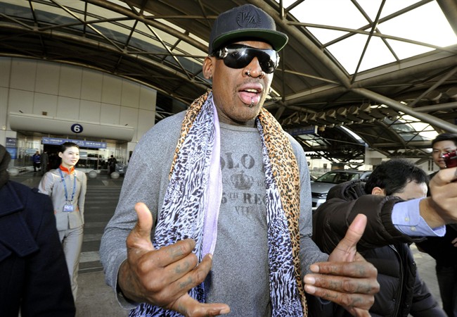 Former basketball star Dennis Rodman speaks to journalists upon arrival at the capital airport in Beijing from Pyongyang, North Korea, Monday, Dec. 23, 2013.