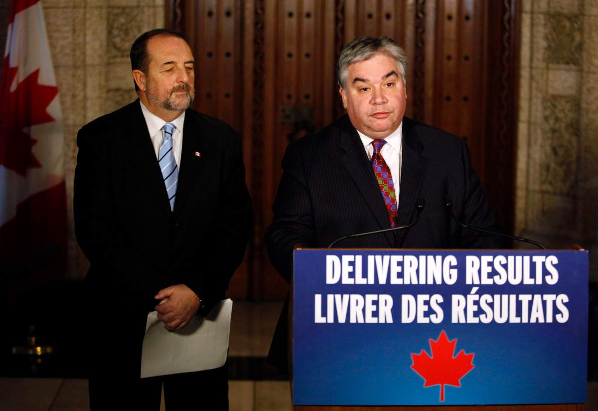 Peter Van Loan, right, Leader of the Government in the House of Commons, and the Denis Lebel, Minister of Infrastructure, make a statement on the government's legislative accomplishments on Parliament Hill in Ottawa on Thursday, December 12, 2013. THE CANADIAN PRESS/ Patrick Doyle.