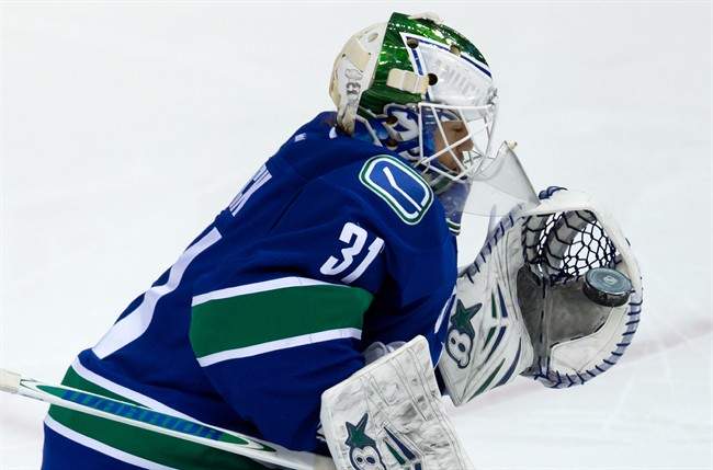 Vancouver Canucks' goalie Eddie Lack, of Sweden, makes a glove save against the Winnipeg Jets during second period NHL hockey action in Vancouver, B.C., on Sunday December 22, 2013. THE CANADIAN PRESS/Darryl Dyck.
